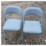 2 blue folding chairs