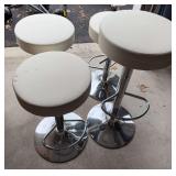 4 adjustable white bar stools with metal bases