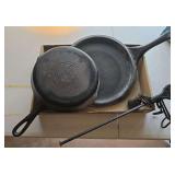 2 cast iron pans and a hand scale