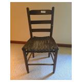 Wooden chair with simple traditional styling. Features a shaped back, wood seat, and turned front legs. Suitable for use as an accent chair, desk chair, or occasional seating.