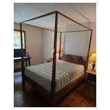 Full-size four-post bed frame with memory foam mattress. Features traditional wood construction with turned posts and matching headboard and footboard. Includes bed frame components and mattress.Locat