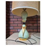 Three mid-century modern lamps including a pair of matching mint-green ceramic table lamps with gold-tone accents and coordinating shades, plus a tall floor lamp with brass-tone base and stem and a cy
