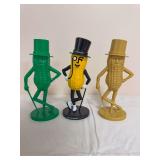Three Planters Mr. Peanut figural banks in green, yellow/black and gold-tone finishes, each depicting Mr. Peanut with top hat, monocle and cane. Shows general age-related wear.