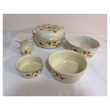 Five-piece Hall Autumn Leaf group including a covered round casserole, oval baker, two round bakers/casseroles in graduated sizes, and creamer, all with gold trim. Several pieces bear Hall’s Superio
