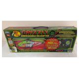 World Tech Toys/Bass Pro Shops Grizzly “Unbreakable Helicopter” 2.4GHz 3.5-channel gyro remote-control helicopter in original box with controller. Packaging identifies it as glow-in-the-dark.