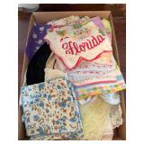 Flat of assorted vintage handkerchiefs and linens in numerous floral, lace-trimmed and printed designs, including a Florida souvenir handkerchief.