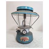Thermos Model No. 8312 pressure lantern with blue fount, turquoise-blue ventilator, clear Thermos/Pyrex globe and wire bail frame. Shows paint wear, oxidation and age-related use.