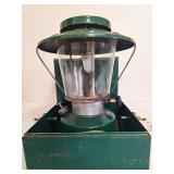 Thermos Model 8326 Lantern with Metal Carrying Case. Green pressure lantern with clear globe, matching green ventilator and wire bail handle, housed in a green metal carrying case; shows age-related f