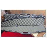 Two molded black hard long gun cases with foam interiors and multiple latches. Both are empty as shown.