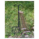 Group including two expanded-metal loading ramps and assorted black metal shepherd’s hooks/plant hangers as shown. Shows surface rust and outdoor wear.