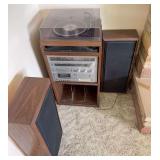 Stereo cabinet with turntable, receiver/tuner, cassette deck and pair of speakers. Stereo powered on, but the turntable could not be gotten to work.