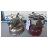Vintage Coleman Single-Burner Camp Stoves. Compact liquid-fuel camp stoves with integral fuel tanks, burner assemblies and pot supports in silver and maroon finishes; shows age-related wear and oxidat