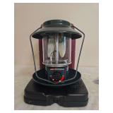 Coleman Model 5154B Propane Lantern with Case. Portable green propane lantern with clear globe, wire frame and electronic ignition, accompanied by fitted black carrying case; shows general age-related