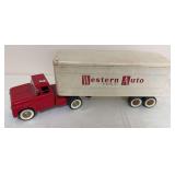 Vintage toy semi with red tractor and white box trailer featuring “Western Auto – the family store” advertising graphics. Whitewall-style tires with age-related wear and discoloration.
