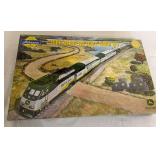 Athearn John Deere HO scale train set in original box with John Deere-themed locomotive and passenger cars. Includes two John Deere die-cast tractors as shown.