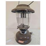 Coleman Model 275 Double-Mantle Lantern – Marked 9/79. Brown painted fount with matching brown porcelain ventilator, clear globe and wire bail handle; shows age-related wear, oxidation and surface s