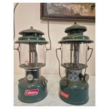 Coleman Models 220H & 220E Lanterns – Marked 5/73 & 1/53. Green double-mantle pressure lanterns with clear globes, porcelain ventilators and wire bail handles; shows age-related paint wear, oxidatio