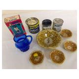 Planters Mr. Peanut grouping including vintage nut tins, Cocktail Peanuts container, molded peanut-design serving bowl and small matching dishes, plus blue glass mug. Mixed ages and condition.