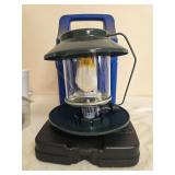 Coleman Propane Lantern with Carrying Case. Green portable propane lantern with clear Coleman globe, single mantle, wire frame and fitted blue carrying case; shows general age-related use.