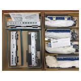 Two flats of assorted model railroad passenger cars and related models, including New York Central and Baltimore & Ohio equipment as shown. Includes boxed and loose pieces with instructions and small 