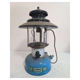 Sears lantern Model 476.72213 with blue fount, black porcelain ventilator, clear globe and wire bail handle; marked 3/69. Shows paint wear, oxidation and age-related use.