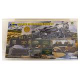 Athearn John Deere Collector’s Edition HO scale Rolling Stock Set, 5th in a series and dated 2001. Includes three boxcars, bay-window caboose and flat car with two 1:87 scale die-cast tractors; numb