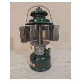 Coleman Model Coleman Model 220E double-mantle pressure lantern marked 6/53, with green fount and matching green porcelain ventilator, clear Pyrex Coleman globe and metal reflector. Shows age-related 
