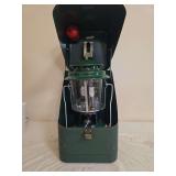 Coleman Model 220J Lantern with Metal Carrying Case – Marked 1/78. Green double-mantle pressure lantern with clear globe and wire bail handle, housed in a green metal Coleman carrying case with fuel