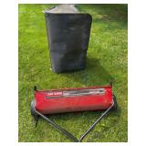Craftsman tow-behind lawn sweeper with chain-drive mechanism, 18-bushel capacity and 12-inch brush designation visible on the housing. Includes collection bag as shown.