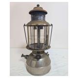 Justrite Mfg. Co. Model 30 pressure lantern with silver-tone fount, mica globe assembly and metal bail handle. Shows oxidation, discoloration and general age-related wear.