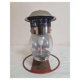 Clayton & Lambert Mfg. Co. lantern with red circular base, clear globe, silver-tone perforated upper housing and mantle as shown. Shows surface wear, oxidation and age-related use.