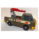 Vintage Mattel V-RROOM! Howler U.S. Army toy truck in olive drab with rear crane/boom assembly and military star graphics. Shows general age-related wear to body and decals.