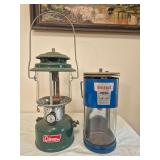 Coleman Model 220F & Bernzomatic TX-750 Lanterns. Includes green Coleman pressure lantern marked 4/69 and blue Bernzomatic TX-750 propane dual-beam lantern; both show age-related wear and surface soil