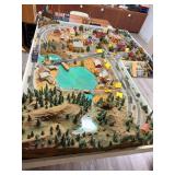 Large detailed model railroad layout featuring multiple tracks, town and farm scenes, bridges, water features, wooded terrain, buildings, vehicles, figures and extensive scenery. Located in the baseme
