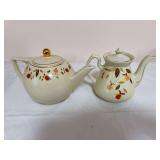 Two Hall Autumn Leaf teapots with gold trim, each in a different form and decoration arrangement. One is marked “Made Especially for The Autumn Leaf Club by The Hall China Co. 1990,” while the oth