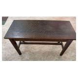 Antique oak bench with rectangular top, stretcher base and interior storage, approximately 36" wide x 21" tall x 16" deep. Shows age-related surface wear.
