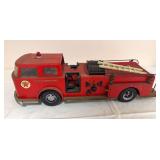 Large vintage Texaco Fire Chief toy fire engine with pressed-steel body, Texaco graphics, roof beacon, hose reels, ladder and firefighting details. Shows age-related wear and oxidation.