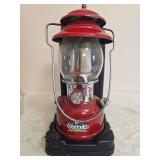Coleman Model 200B Red Lantern with Case – Marked 8/95. Red single-mantle pressure lantern with matching ventilator, clear globe and carrying base/case; shows general age-related use.