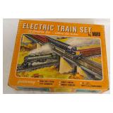 Vintage Marx electric train set in original illustrated box featuring steam-type locomotive, remote control, knuckle couplers and 25-watt transformer. Bonus railroad log book included with the lot.