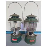 Coleman Models 220J & 220F Lanterns – Marked 2/79 & 2/66. Green double-mantle pressure lanterns with clear globes, porcelain ventilators and wire bail handles; shows age-related wear, oxidation and 