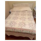 Full-size bed with decorative white painted headboard, mattress, box spring and floral quilt/linens as shown.