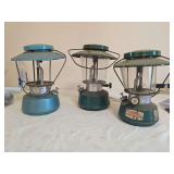 Three Thermos Pressure Lanterns – Models 8326, 8312 & 8316. Group of three vintage pressure lanterns in assorted finishes with glass globes and wire bail handles; shows varying age-related wear, oxi