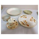 Group of Hall Autumn Leaf china including large round serving platter, shallow serving bowl, oval baker, small bowl, and covered condiment jar with matching underplate. Several pieces bear Hall “Sup