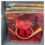 Group of vinyl record albums including Christmas and big band selections with record stand as cataloged. Visible albums include Hallmark The Best Loved Christmas Carols and other assorted titles.