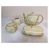 Four-piece group of Hall China Autumn Leaf Nautilus pieces made for the National Autumn Leaf Collectors Club, comprising a 1996 5-cup Nautilus teapot with lid, 1997 Nautilus creamer, 1997 Nautilus cov