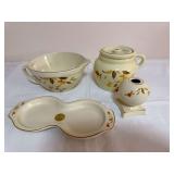 Four China Specialties Autumn Leaf pieces comprising a handled serving bowl, lidded one-handle bean pot, double-compartment serving dish and spherical vase on square base, all with cream glaze, Autumn