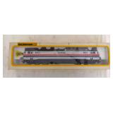 Boxed Bachmann HO scale Amtrak No. 951 electric locomotive in silver with red, white and blue striping. Packaging identifies the locomotive as lighted.