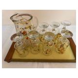 Large group of Autumn Leaf-pattern glassware including decorated glass pitcher, seven stemmed glasses, assorted tumblers and additional serving/display pieces, together with an Autumn Leaf decorated w