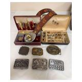 Group includes horse-themed leather belt with large buckle, assorted advertising and occupational belt buckles, cufflinks, tie clips, costume jewelry and watch in cases. Buckles include Remington, J.I