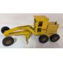 Vintage Tonka pressed-steel Road Grader in yellow with six rubber tires and adjustable center grading blade. Shows paint wear and age-related use.